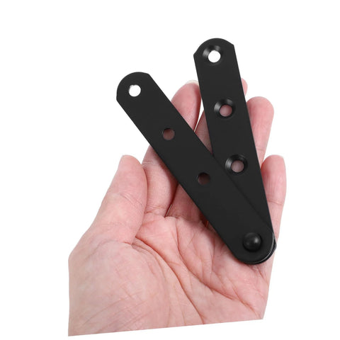 Hand-held close-up of two black stainless steel concealed hinge plates with mounting holes