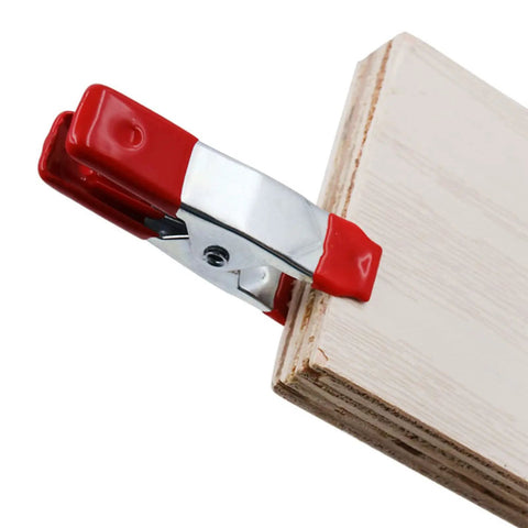 Heavy Duty Metal Spring Clamps 2 Inch Nonslip Clips for Photography and Woodworking set of 10 gripping a wooden board
