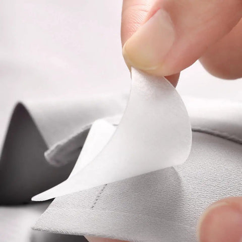 Premium White PVC Adhesive Collar Stays 240 Pack Shirt Collar Protectors For Men Dress Shirts being applied to a shirt collar.