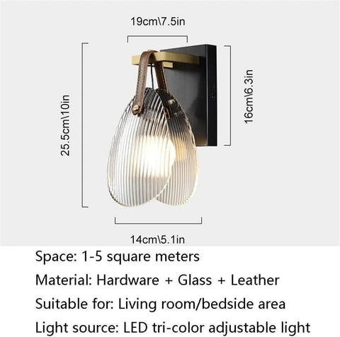 Fluted Glass Wall Sconce Ribbed Shade Leather Strap Brass Finish Metal Light 10 Inch Height mounted on wall with adjustable lighting for home use.