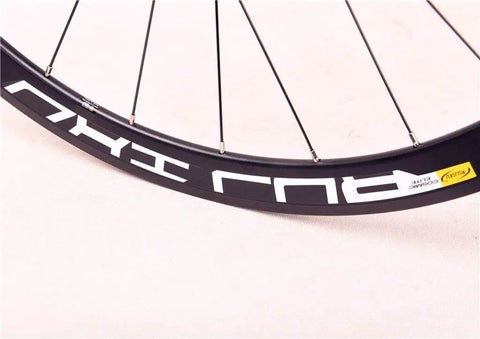 Close-up of Road Bike Wheelset 700C with carbon fiber hubs, dope double wall alloy rims, front CV brake, for training and competition.