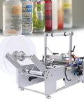 Semi Automatic Round Bottle Labeler For 20 To 120 Mm Diameter High Speed Packaging Applicator with label roll and control panel.