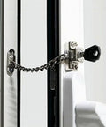 Deadlock Secure Stainless Steel Window Chain Lock And Door Cable Restrictor installed on a window with a key for child safety and theft prevention.