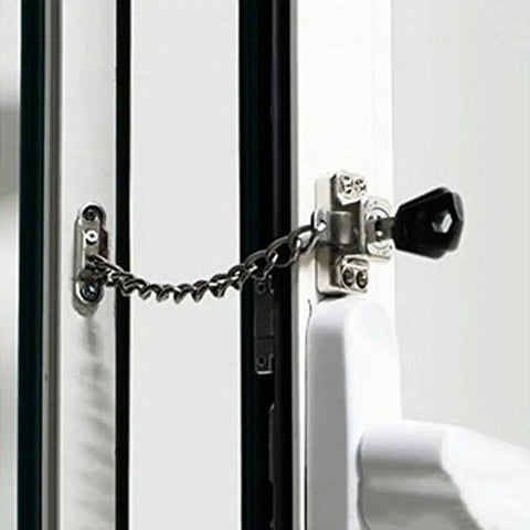 Deadlock Secure Stainless Steel Window Chain Lock And Door Cable Restrictor installed on a window with a key for child safety and theft prevention.