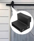 Barn Door Roller Stopper Set For Flat Track Sliding Doors Noise Reducing Metal With Rubber Gasket Includes Mounting Wrench Two Pieces Track Width Compatible Hardware Black Powder Coated Finish shown in use on a sliding door.