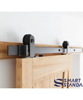 5 Foot Top Mount Sliding Barn Door Hardware Kit With Pull Handle And Floor Guide Fits 30 Inch Wide Door Panel T Shape Hanger DIY Friendly Easy To Install Premium Quality, showing close-up of door mounted on rail with T shape hanger in use.