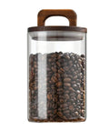 Premium Glass Coffee Canister With An Airtight Wooden Lid To Keep Your Daily Grind Fresh, filled with coffee beans.