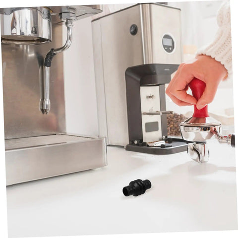 Barista Grade Heatproof Rubber Steam Wand Sleeve for espresso machines on counter near coffee maker and tamper.
