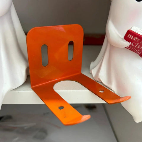 Heavy Duty Iron Power Tool Hanger Wall Mount For Garage And Shed Organization in orange on a shelf
