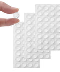 Clear Self Adhesive Cabinet Bumpers Shield Furniture From Harsh Door Slams And Cut Down Household Noise Soft Silicone Rubber Pads in hand.