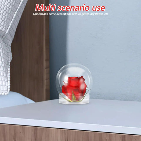 Clear 4 Inch Snow Globe Kit with fillable plastic ball and red flower on minimalist table for DIY decor and gift ideas