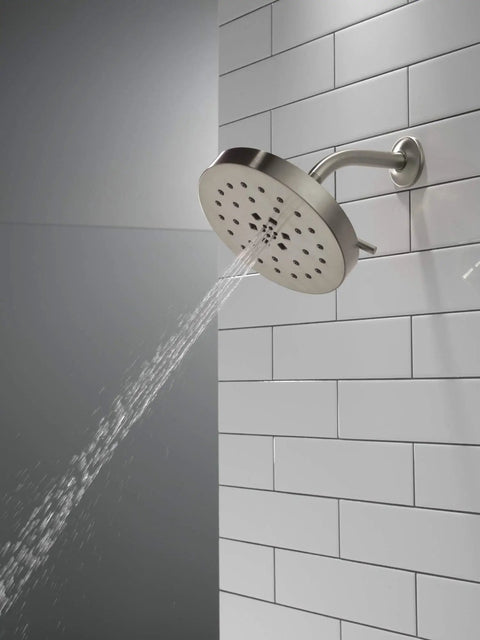 H2Okinetic 4-Setting UltraSoak Shower Head in Stainless Steel - Drenching Rainlike Spray With Water Sculpting Tech on tiled wall.