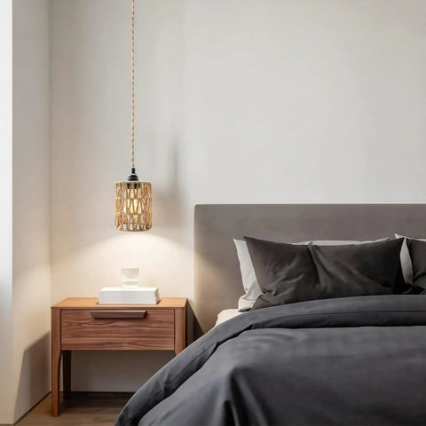 Amp Up Your Space With This Straight Up Badass Boho Pendant Light Featuring A Heavy Duty 16.5 Ft Plug In Swag Cord And Handwoven Rattan Cylinder Shade For Zero Hassle Setup And Chill Room Vibes, hanging over a bedside table.