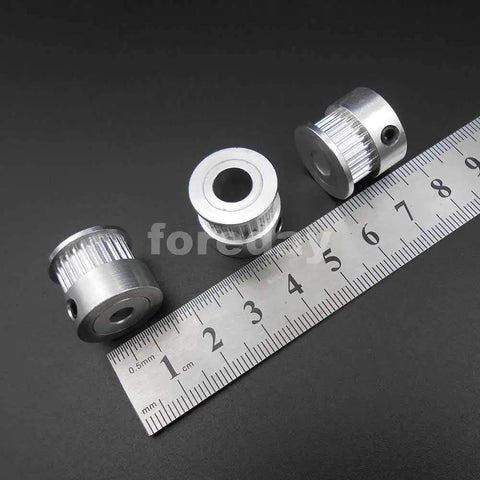 Heavy Duty Alloy GT2 Synchronous Timing Pulley Five Pack With 25 Teeth 6mm Wide And 8mm Bore, showing three pulleys and a measuring ruler.
