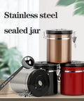 Legit Airtight Coffee Canister With Sweet Built In Scoop And Vacuum Sealed Stainless Steel Design Featuring One Way Degassing Valve Plus Handy Date Tracker Lid To Keep Your Beans Tea Or Flour Crisp And Fresh For Longer, showing four canisters and scoop.