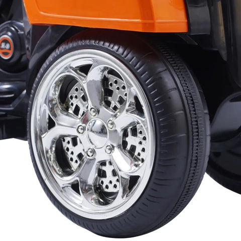 6V Battery Powered Electric Chopper Style Motorcycle Ride On Trike Toy For Kids Ages 3 To 6 Orange With Realistic Design Easy Pedal Drive Safe Beginner Friendly Features close-up chrome wheel and tire