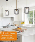 One Light Lantern Pendant With Adjustable Stem Black And Brushed Brass Farmhouse Chandelier Clear Glass Cage Shade over kitchen island