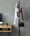 Industrial decor with black metal rack, shirt, and bag in modern office setting