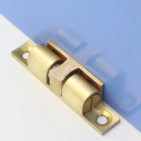 Double Ball Cabinet Door Catch With Adjustable Tension Roller Latch in copper, mounted on blue and white surface