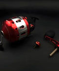 Bowfishing Spincast Reel For Slingshot Bow Left Or Right Handed, all-metal construction, shown disassembled on dark background.