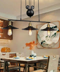 Fresh Vintage Industrial Billiard Chandelier Features Easily Adjustable Pulley Lift System In Classic Black Metal Three Light Ceiling Hanging Lamp Solid Pick For Dining Room Or Chill Loft displayed above a dining table.