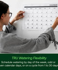 Person adjusting calendar, representing Program-Based Indoor Irrigation Controller With WiFi Ready Capability And 6 Zone Scheduling.