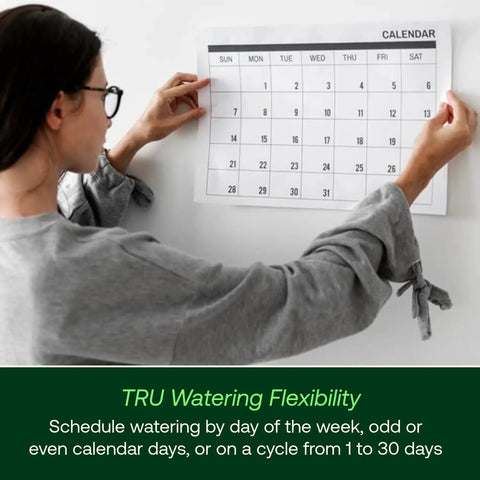 Person adjusting calendar, representing Program-Based Indoor Irrigation Controller With WiFi Ready Capability And 6 Zone Scheduling.
