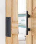 Built Like A Tank 7 Foot Sliding Barn Door Hardware Kit featuring steel handles on a wooden barn door.