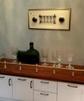 Kickass Gallery Rails For Shelves 3 Pack 15.7 Inch Aluminum Alloy Rods displayed on a wooden shelf with glassware.