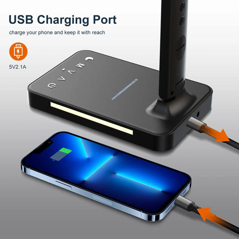 LED Desk Lamp With Wireless Charger And USB Port, Black Finish, charging phone on desk, side view