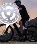 Cyclist with bike featuring Beefy Disc Brake Rotor For Bikes And Ebikes, 180mm And 203mm Options, 6 Bolt Mount, 3mm Thick Stainless Steel
