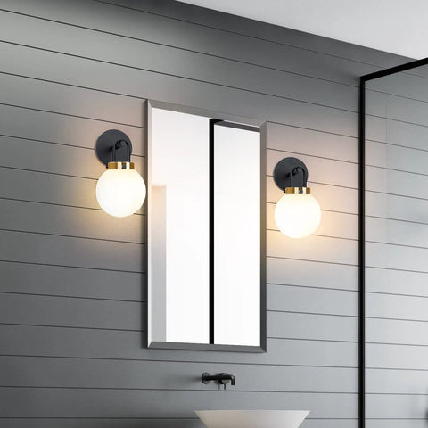 Two Pack Chic Modern Wall Sconces Matte Black And Gold With Milky Glass Globe Vanity Lighting in bathroom by mirror