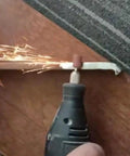 Using Assorted 100 Piece Grinding Stones Set With One Eighth Inch Shank For Rotary Tools to grind metal, sparks visible