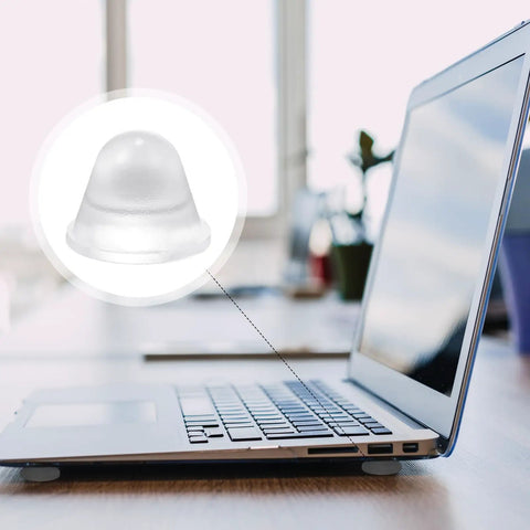 Close-up of Heavy Duty Thirty Two Piece Cone Shaped Clear Rubber Bumpers With Powerful Self Adhesive Backing for laptop protection.
