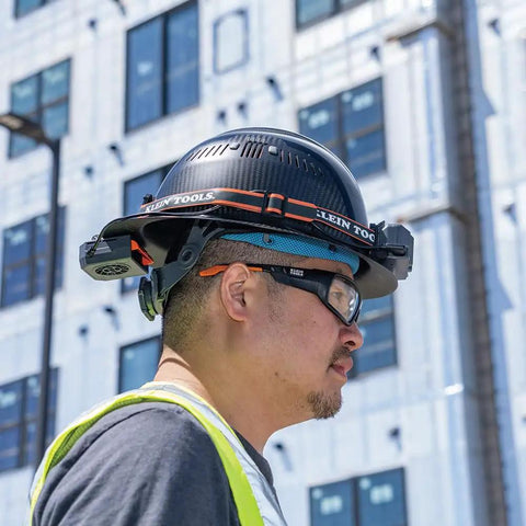 Man wearing hard hat with rechargeable portable cooling turbo fan, 3-speed, dual-mount strap, adjustable vent, long battery life