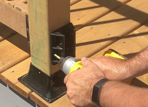 Person installing Beefy Sturdy 2x4 Railing Hangers For Wood Deck Railings Actual 1.5 x 3.5 Black Heavy-Duty Reinforced Polypropylene