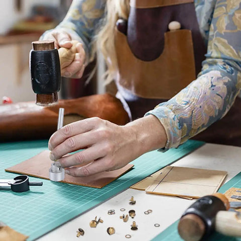 Person using 20 Piece Boot Hook Kit With Brass Shoelace Eyelets And Rivets, Press Stud Tools on leather surface