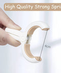 Close-up of hand holding a 12 Pack Heavy Duty Plastic Clothes Pins Featuring Anti Rust Springs And Non Slip Silicone Pads.
