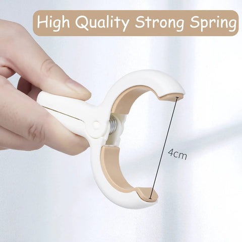 Close-up of hand holding a 12 Pack Heavy Duty Plastic Clothes Pins Featuring Anti Rust Springs And Non Slip Silicone Pads.