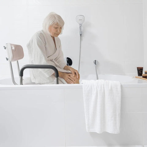 Senior using Deluxe Spa Shower Chair With Arms And Back For Safe Bathing No Slip Stability in bathroom, white and light gray design