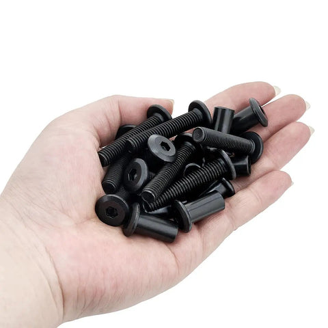 25 Piece M8x40mm Black Furniture Bolts And Cabinet Connector Screws With Barrel Nuts Kit held in a hand, showcasing heavy duty design.