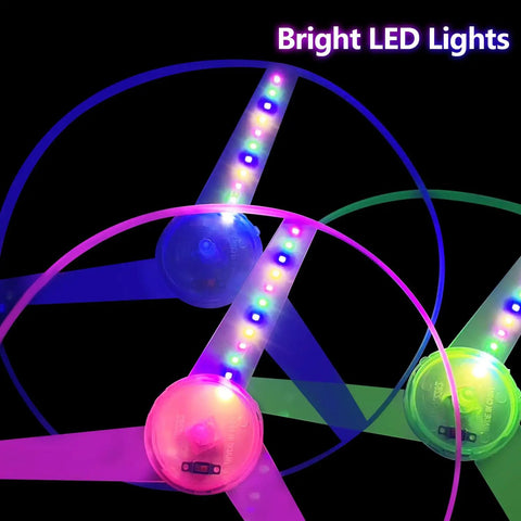 LED Flying Saucer Toys 4 Pack With Built In Flashing Lights for kids, colorful discs glowing in the dark for parties and games.