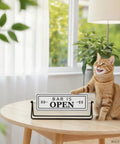Smooth Flipping Open Closed Sign, Handmade Metal Counter Decor For Your Cozy Home Bar Or Office Coffee Spot With Black Stand And Embossed Lettering Straight Up Real Deal on a table with a cat.