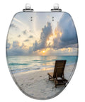 Elongated deck chair sandy beach waters edge seas Toilet Seat featuring a beautiful sunset and tranquil ocean view.