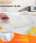 Hand holding Gallon Vacuum Sealer Bags 11x16 Inch Heavy Duty BPA Free with lemons sealed, showing embossed channels.
