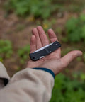 Person holding Six Point One Inch Lightweight EDC Folding Knife With Stainless Steel Blade USA Made Lock Back Tactile Grip Slim Pocket Size