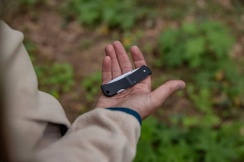 Person holding Six Point One Inch Lightweight EDC Folding Knife With Stainless Steel Blade USA Made Lock Back Tactile Grip Slim Pocket Size