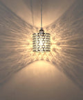 Three Pack Polyhedral Crystal Pendant Lights With Nickel Finish For A Sleek Modern Vibe Crystal Shade Perfect For Dining Room Kitchen Island Living Room Or Hallway Contemporary Pendant Lighting Fixture showing light dispersion on wall.