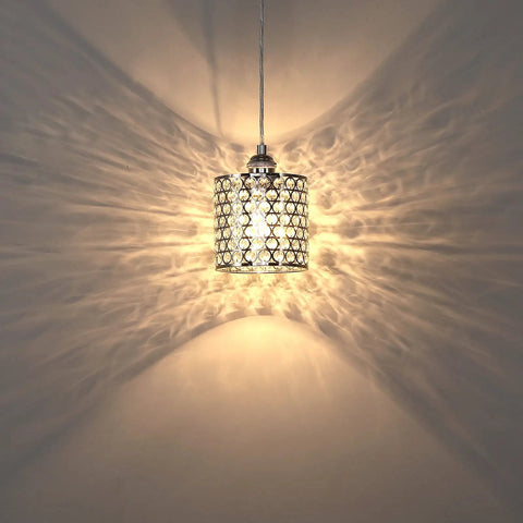 Three Pack Polyhedral Crystal Pendant Lights With Nickel Finish For A Sleek Modern Vibe Crystal Shade Perfect For Dining Room Kitchen Island Living Room Or Hallway Contemporary Pendant Lighting Fixture showing light dispersion on wall.