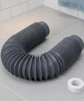 CONGARTENO Flexible Bathtub Drain Pipe Freestanding Tub Drain Kit Black curled pipe on bathroom floor with plumbing tape.